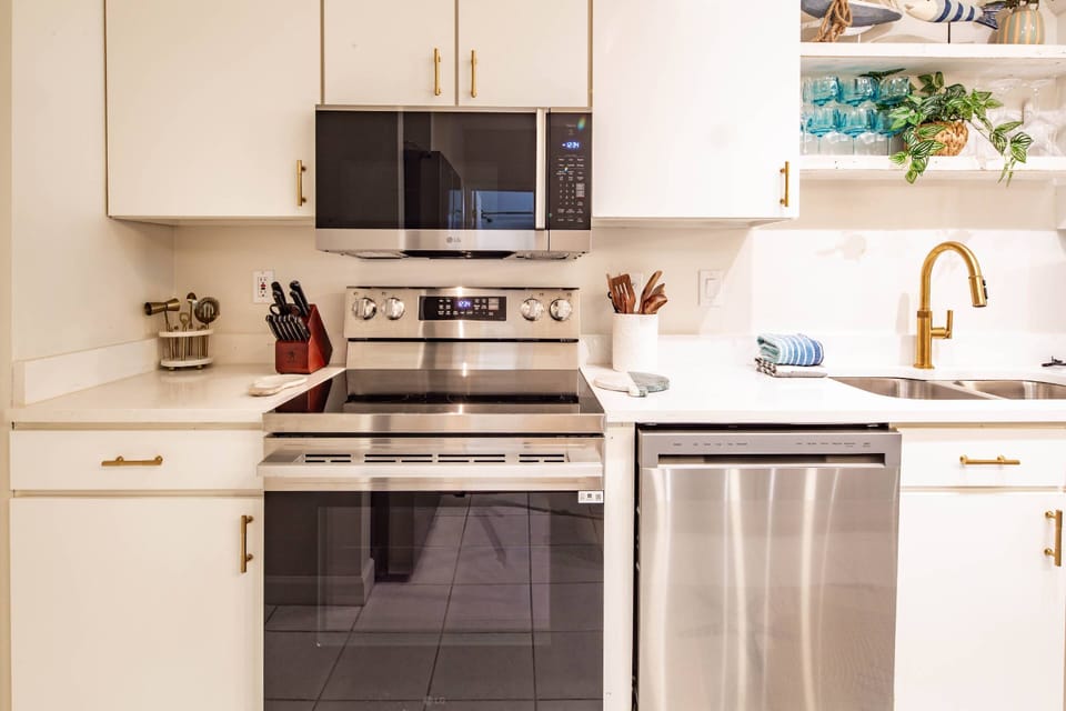 The kitchen features an elecric range, microwave and dishwasher.