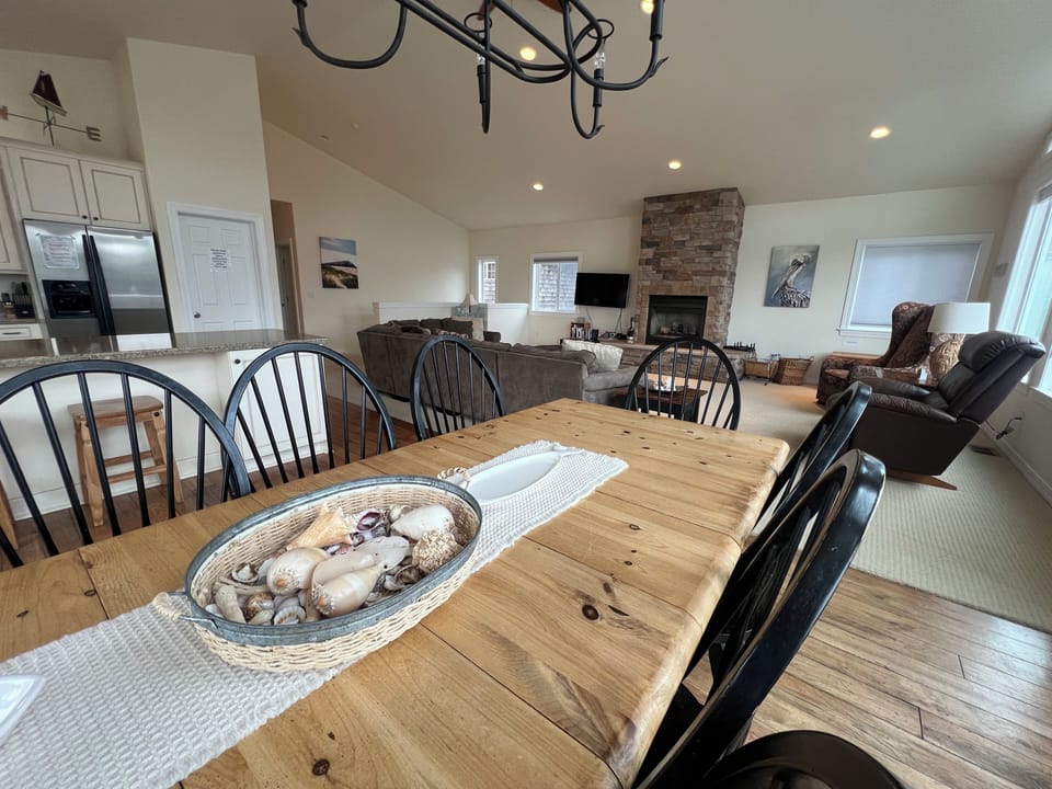 Rustic wood beams and unique nautical touches create a cozy, inviting space where you'll gather for meals and make memories around the table.