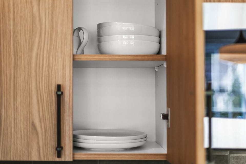 canmore-str-kitchen-cabinet-white-bowls-plates-well-stocked-dishware