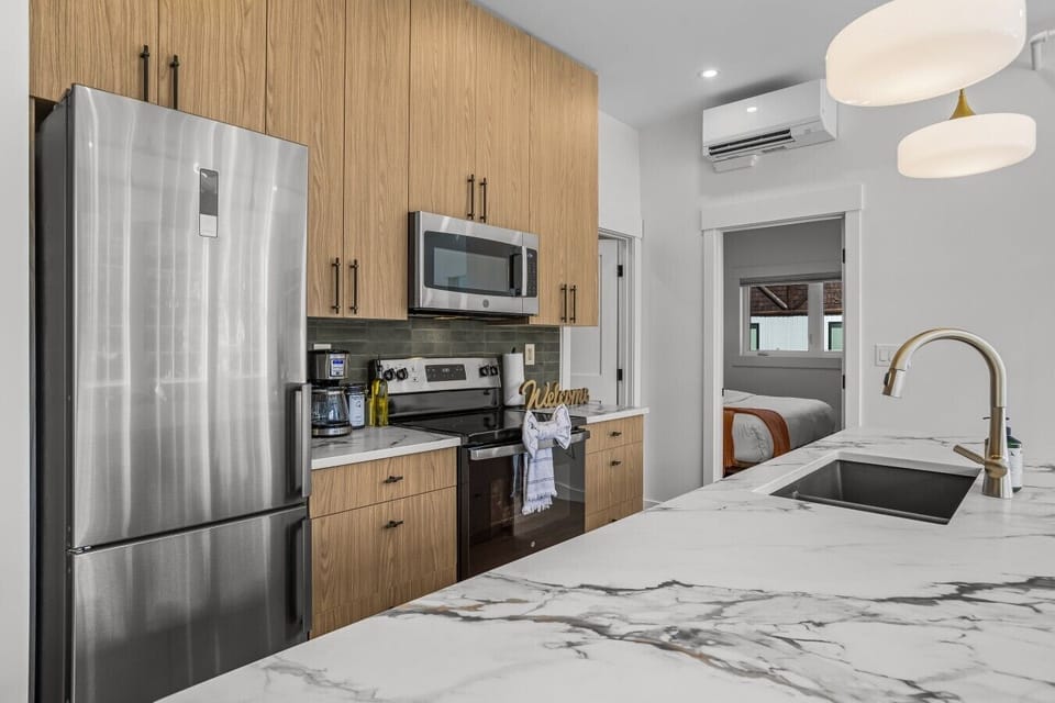 canmore-str-kitchen-stainless-fridge-range-microwave-wood-cabinets