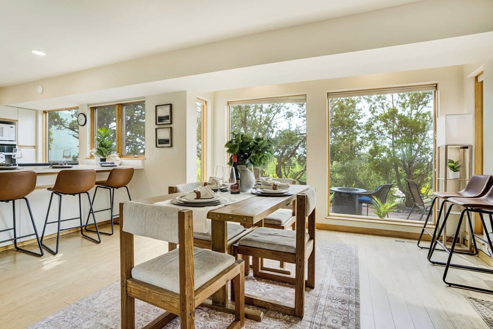 Sun-filled dining area with oversized table seating flows seamlessly into the spacious kitchen, creating the perfect setup for family dinners, group gatherings, and game nights.