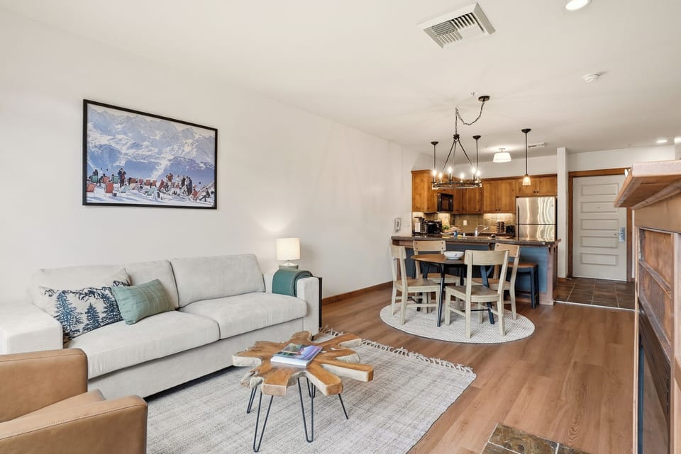 Bright open living space with cozy seating and a stylish full kitchen