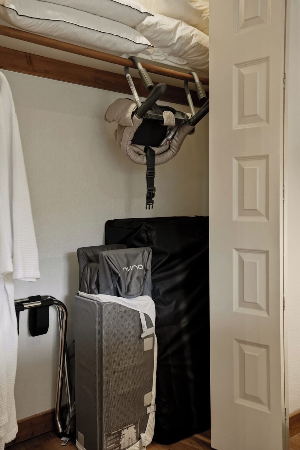 Organized storage closet with extra linens and handy family-friendly gear