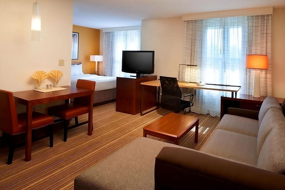 Unwind in a spacious suite with cozy seating and soft light.