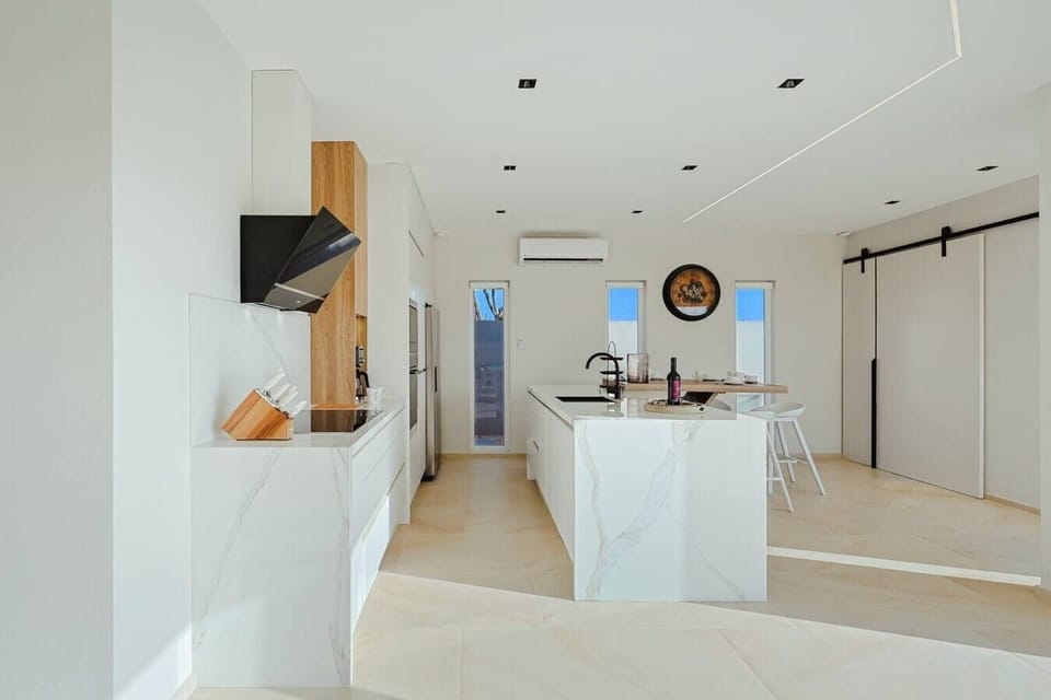Gather around the spacious island, enjoy a home-cooked meal, and make the most of the villa’s bright, open layout.