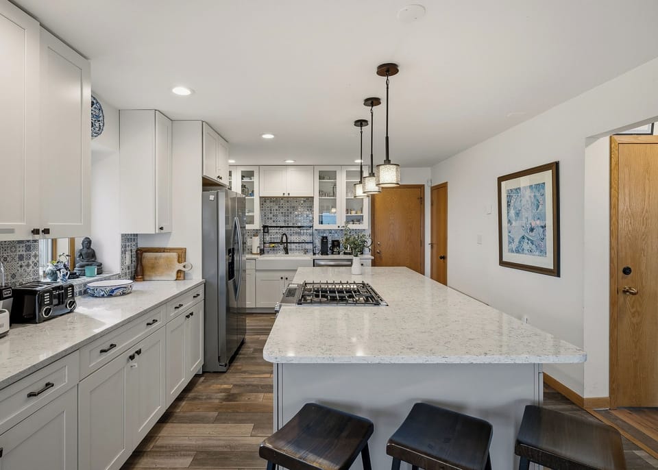 Modern kitchen with a spacious island, gas cooktop, and sleek finishes for easy group meals.