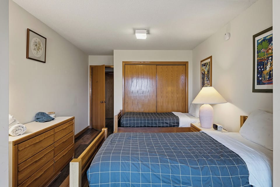 Bedroom 3 features 2 full beds, mountain views and a desk.