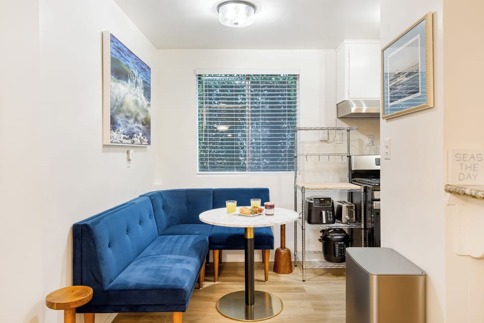Enjoy morning coffee in this charming, blue velvet banquette dining corner.