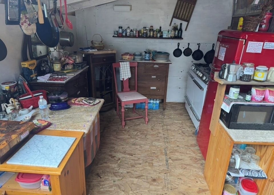 Community open air kitchen with natural gas stove (no oven yet), shared frig
