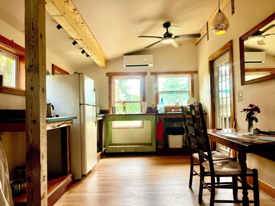 Full kitchen with induction stove, Breville 3 in 1 oven, microwave and toaster.