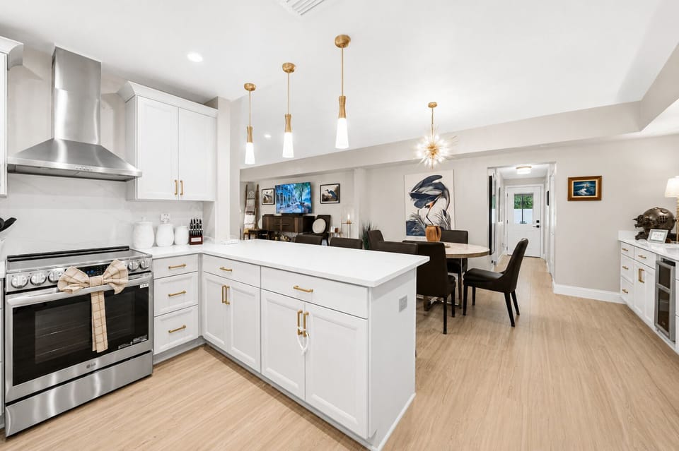 Spacious chef’s kitchen with oversized island, open layout, and seamless flow into the dining area.