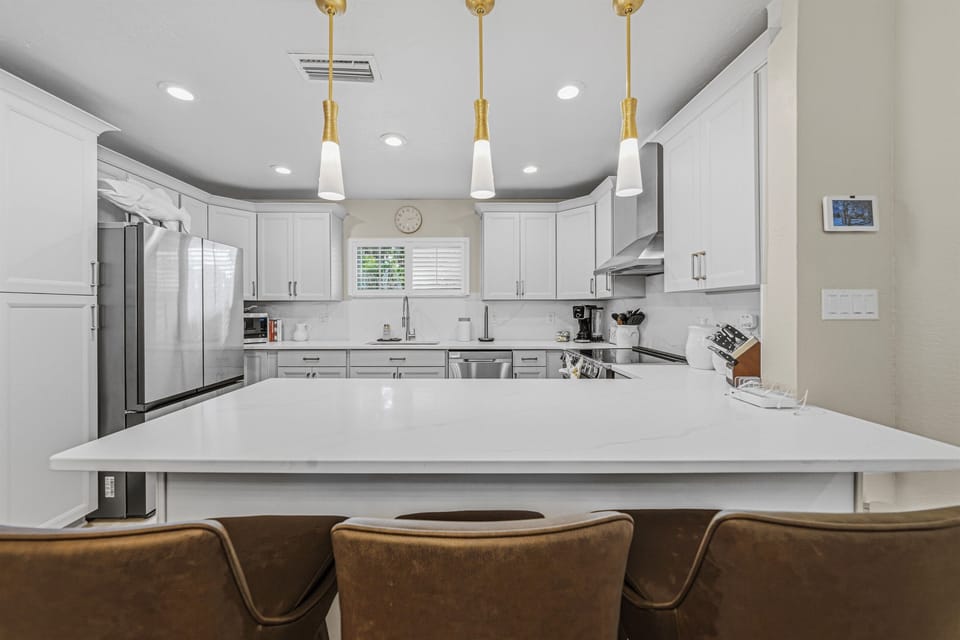 Large breakfast bar seating area perfect for casual dining, morning coffee, or entertaining guests.