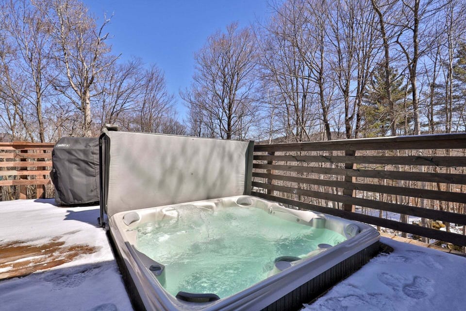Step into the hot tub for an outdoor soak surrounded by trees.