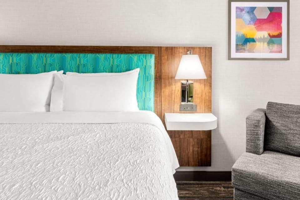 Sink into crisp linens and enjoy warm bedside lighting.