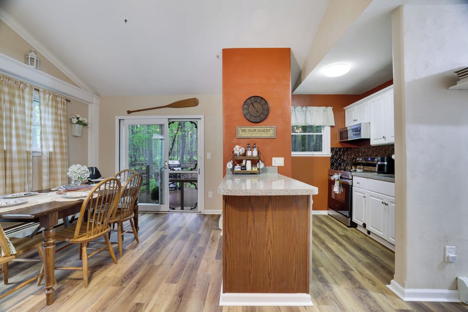 Gather for meals in this bright and cozy dining area featuring wooded views