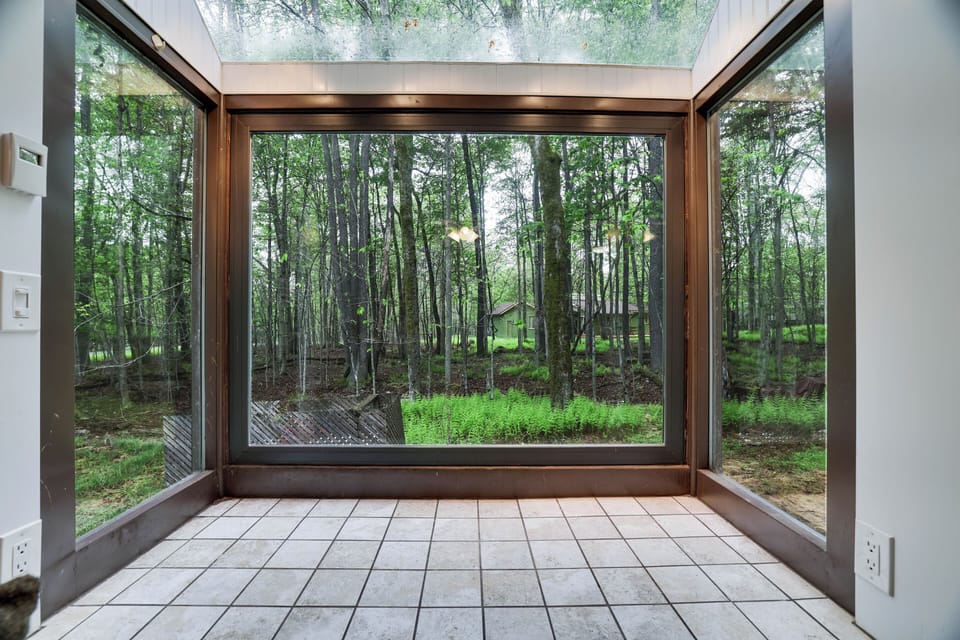 Enjoy natural light and peaceful woodland views through a large picture window.