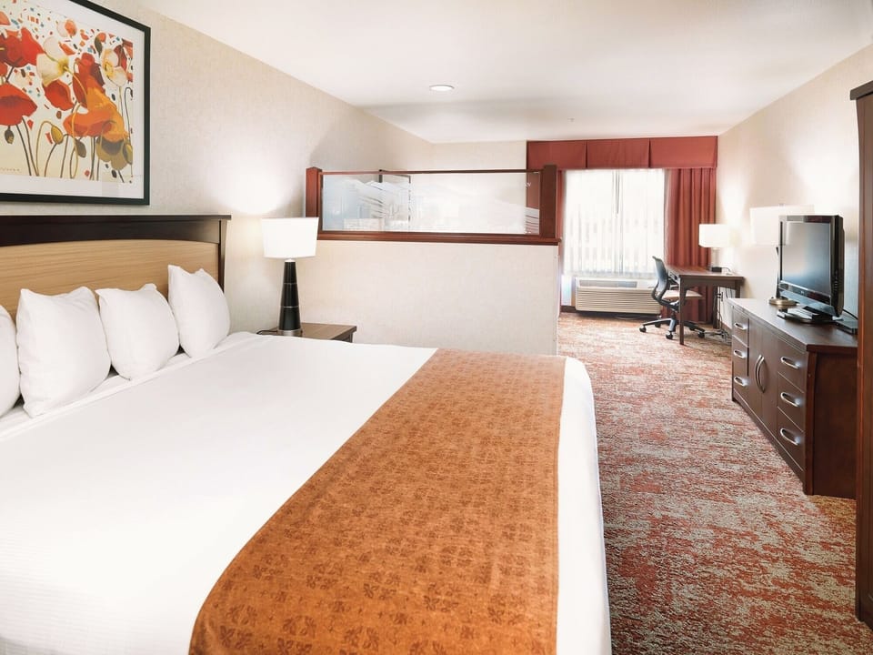 Recharge in a calm, spacious bedroom with plenty of room.