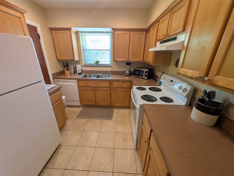 Full kitchen with oven and dishwasher