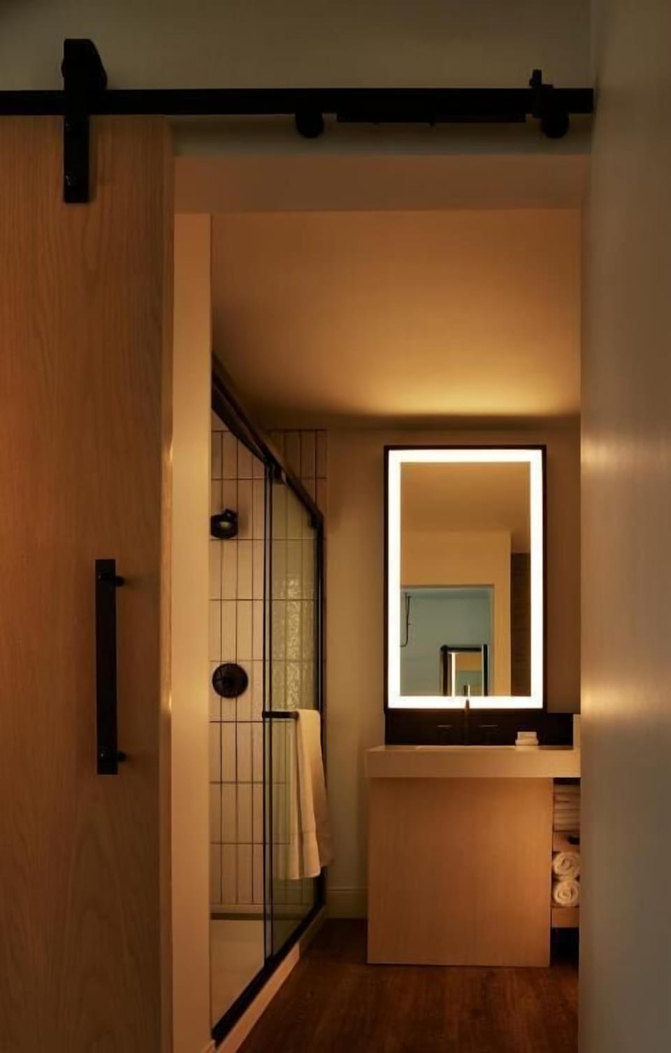 Refresh in a sleek shower with warm, calming lighting.