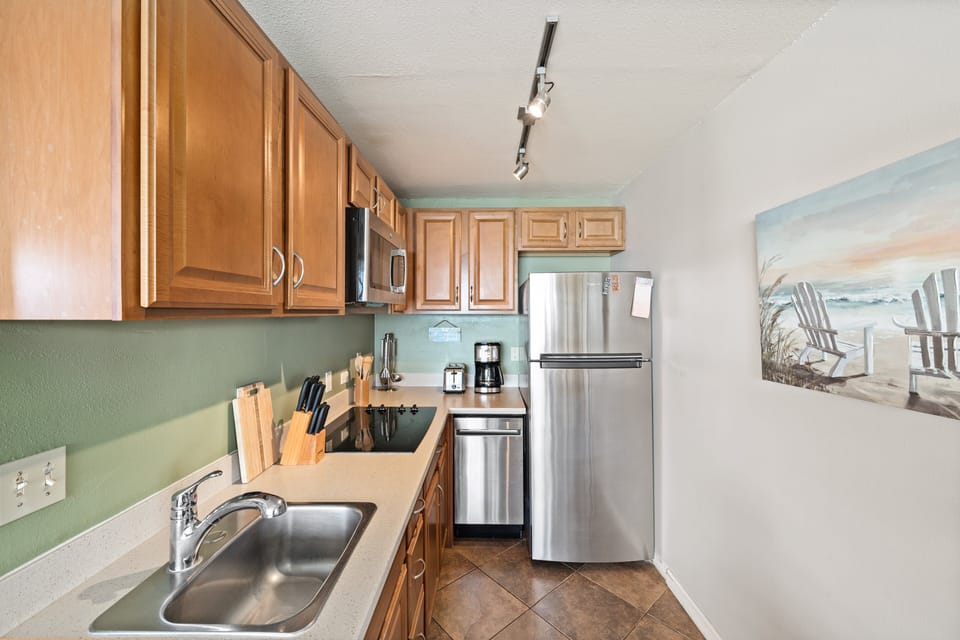 Fully equipped kitchen with stainless steel appliances, ample cabinet space, and modern countertops.