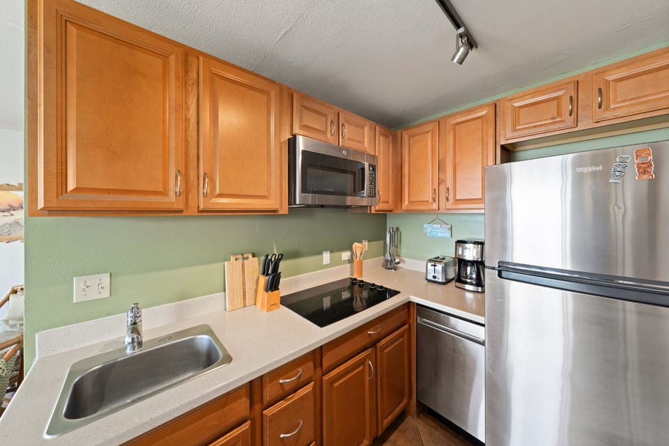 Clean and functional kitchen with sleek stainless steel finishes and a convenient layout for easy meal prep.
