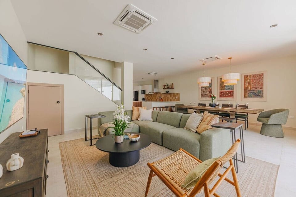 Modern open plan apartment with stylish decor, natural light, and cozy living spaces perfect for a relaxing stay.