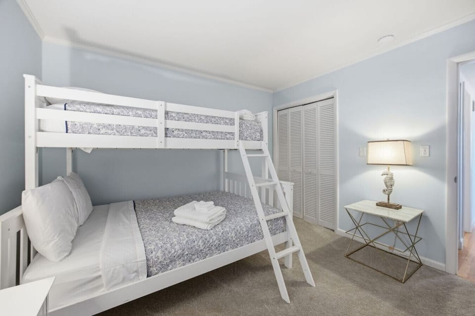 Twin-over-full bunk room with soft coastal décor and comfortable sleeping space
