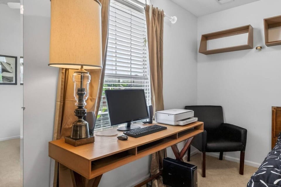 Stay productive with a dedicated workspace complete with a computer setup and comfortable seating.