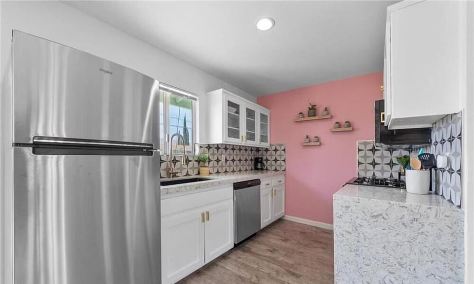 Fully stocked retro-inspired kitchen featuring stainless steel appliances