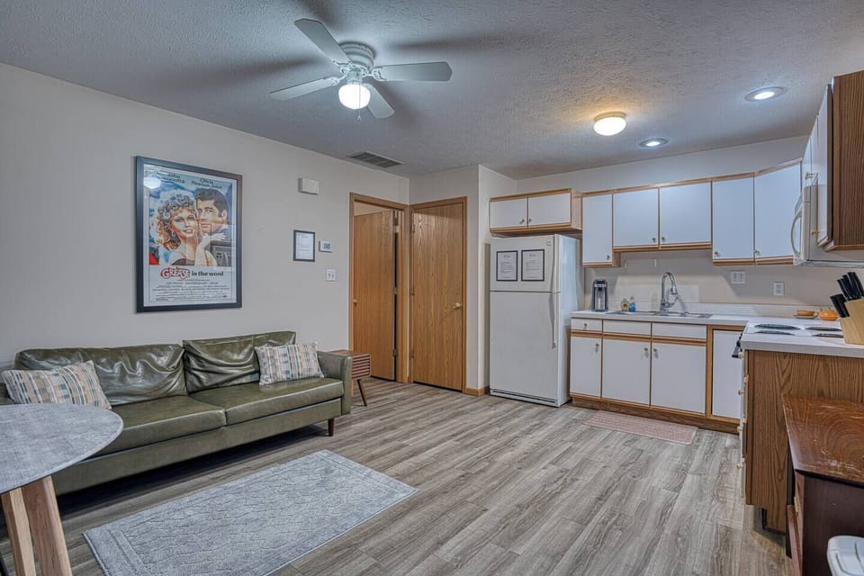 Bright retro‑modern living room with cozy seating, warm natural light, and a relaxing vibe — perfect for unwinding after exploring Downtown Newburgh.