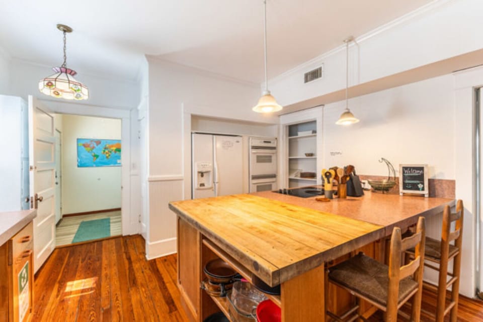 Open kitchen layout with island seating, built-in ovens, and a roomy fridge.