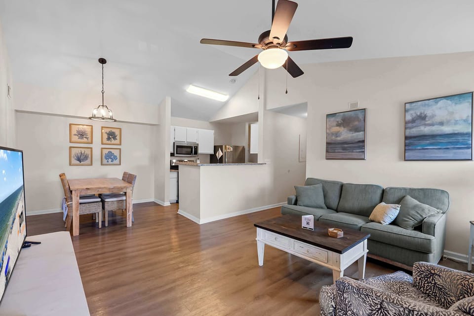 Spacious living area with sofa sleeper, TV, and open layout