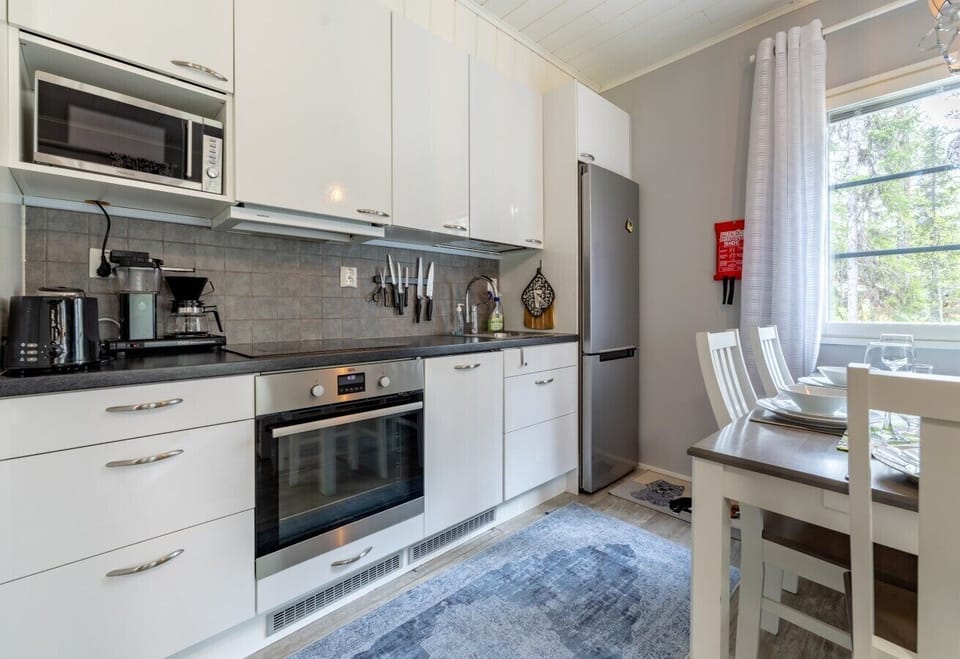 Cook with ease using a fully equipped, modern kitchen that features ample counter space and essential appliances for preparing home-cooked meals. Its close proximity to the dining table makes serving and cleanup quick and simple.