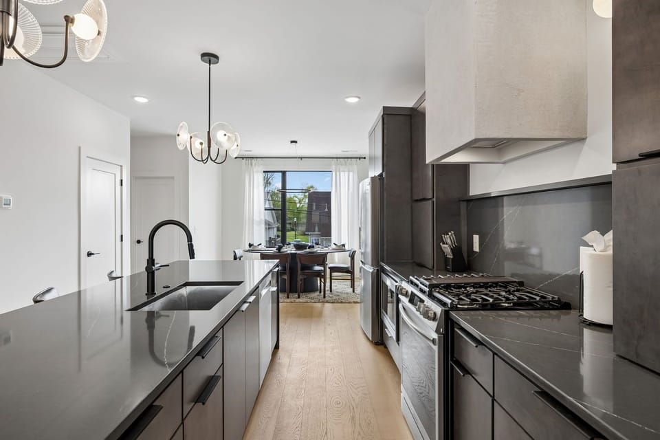 Kitchen: A modern kitchen with sleek cabinetry, stainless steel appliances, and ample counter space.