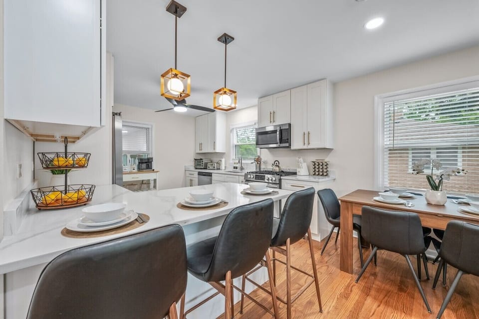 The kitchen is ready with a gas stove, full-size appliances, island seating, and room to prep and serve three full meals a day.