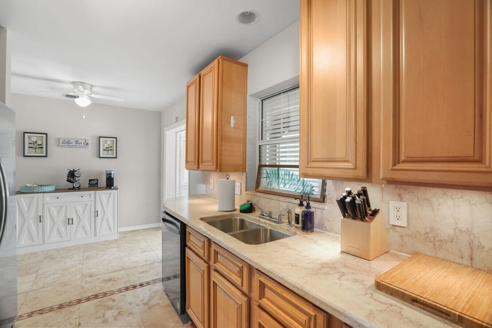 Kitchen offers all stainless steel appliances, granite counter tops, and view of the twin bedroom