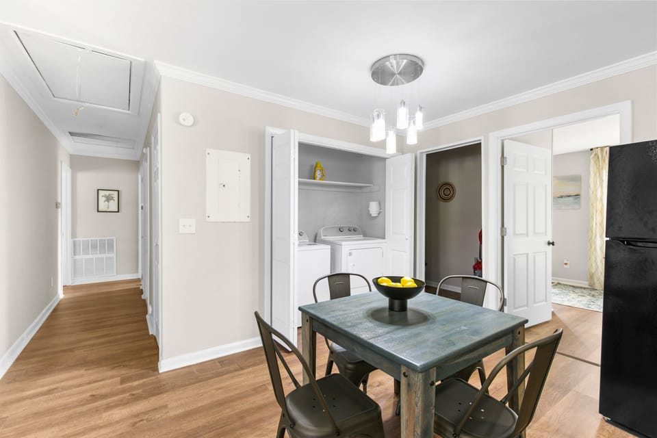 Gather around the dining table for four, conveniently located off the kitchen. It’s a great spot for casual meals, game nights, or winding down after a full day out.
