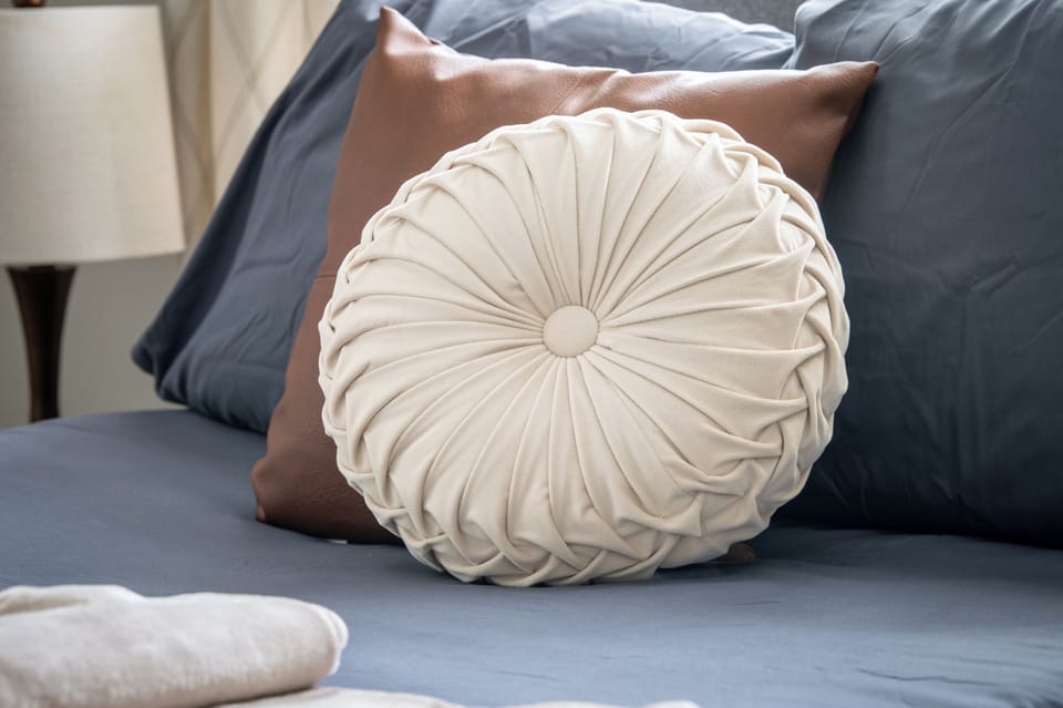 A closer look at the cozy details waiting in this bedroom, with soft layers and comfortable touches that make settling in for the night feel easy.