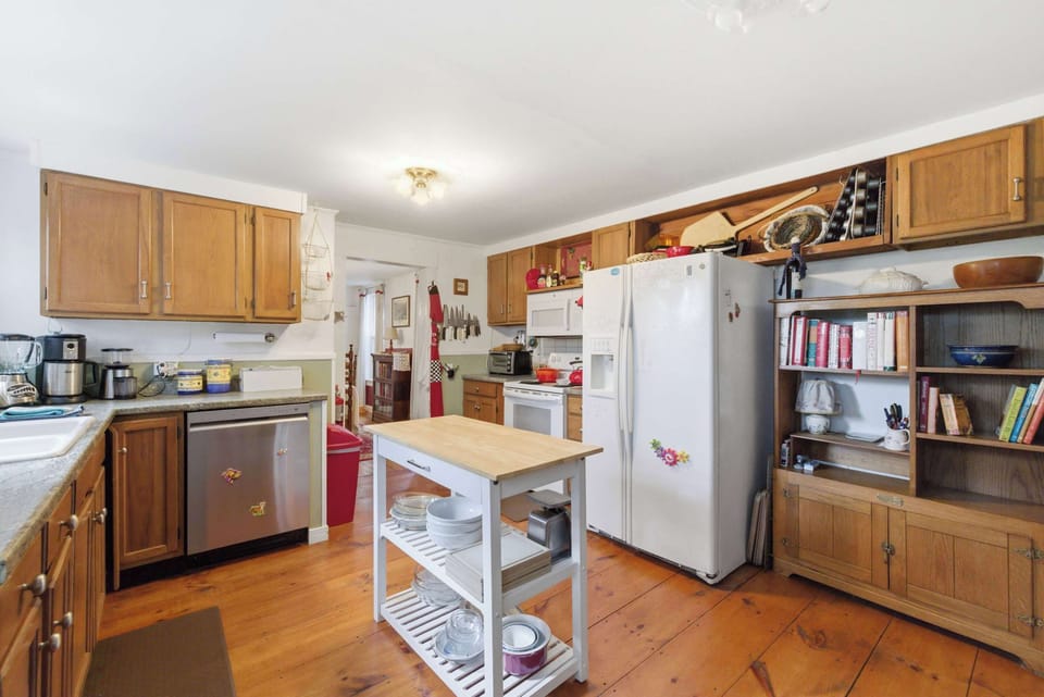 The spacious farmhouse kitchen features a central island layout perfect for group meal prep.