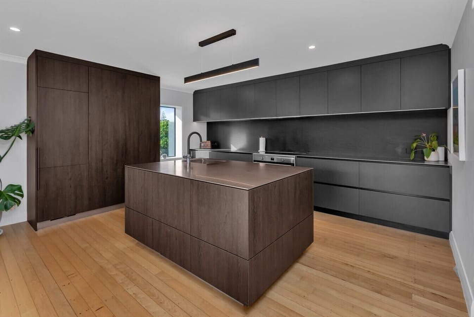 Modern, fully equipped kitchen featuring a large central island. Plenty of prep space. Perfect for cooking and socializing.