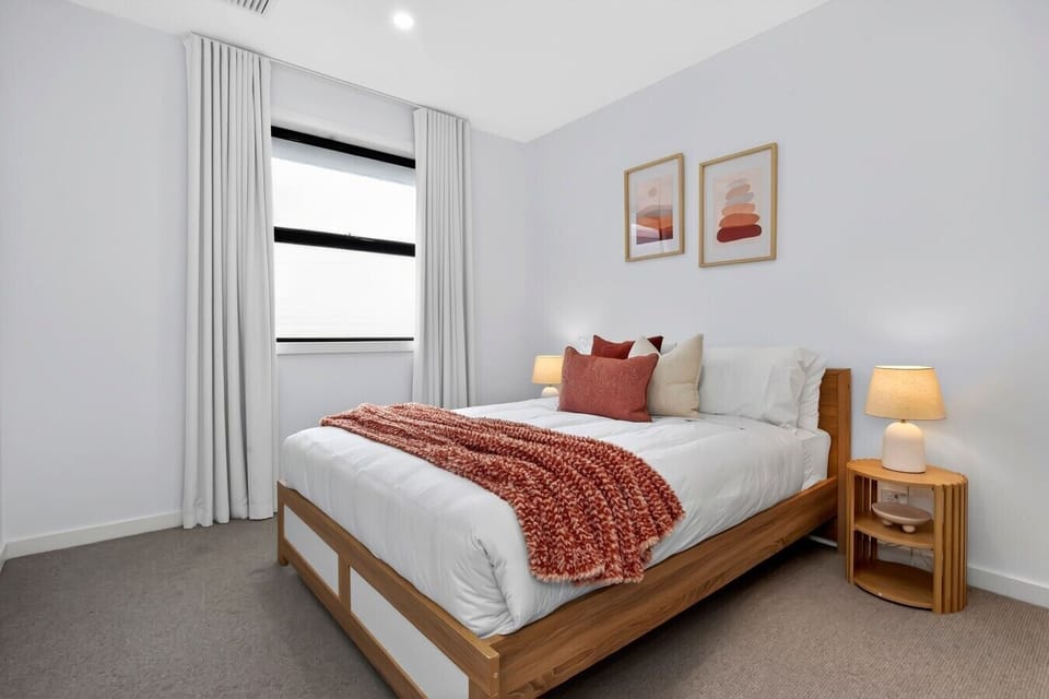 Bright queen bedroom with terracotta accents