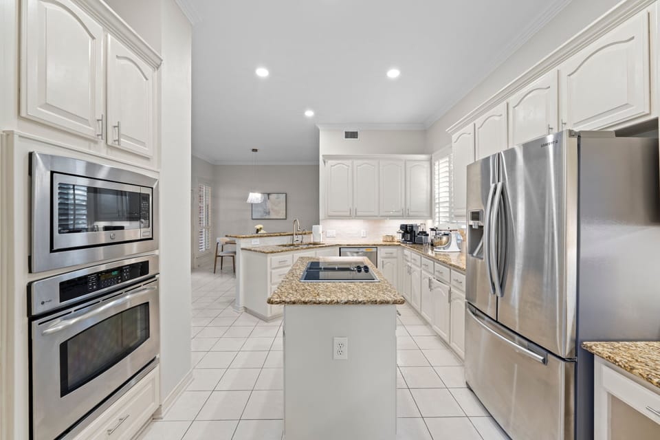 Clean, open kitchen where everything feels within reach—perfect for slow mornings, easy meals, and gathering without effort.