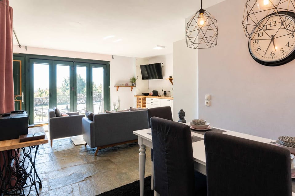 The dining and lounge area invites slow breakfasts, shared meals, and relaxed evenings after exploring Drama and the surrounding mountains.