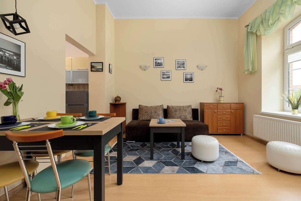 Bright and welcoming living area with elegant wooden flooring and cozy modern décor.