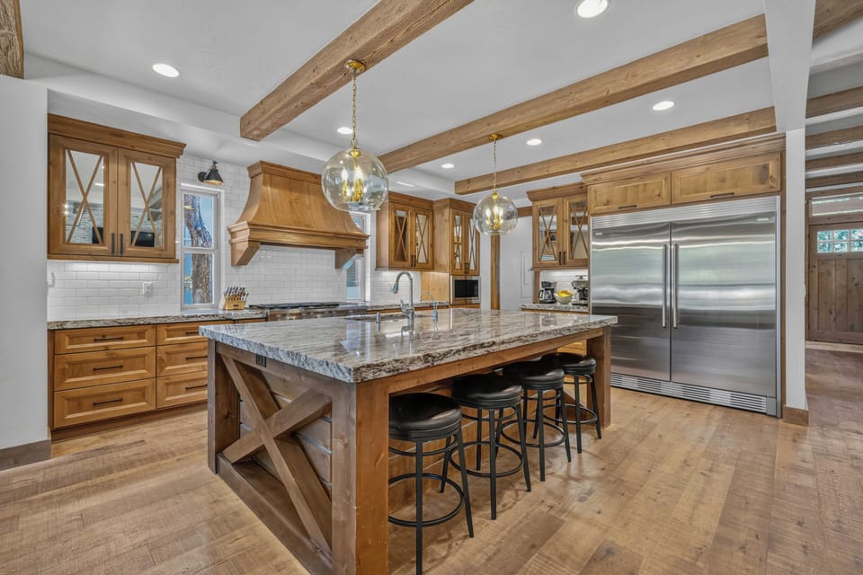 Your gourmet kitchen awaits with stunning granite countertops, custom wood cabinetry, and professional-grade appliances—perfect for preparing memorable meals during your stay.