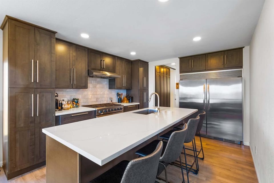 Modern kitchen w/ coffee maker, island seating for 4, & ocean views