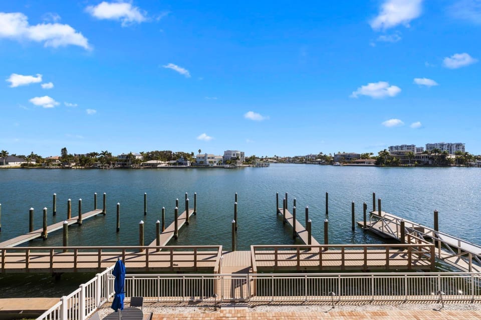 Gaze at the tranquil waterway dotted with docks, perfect for boating adventures and quiet sunsets.