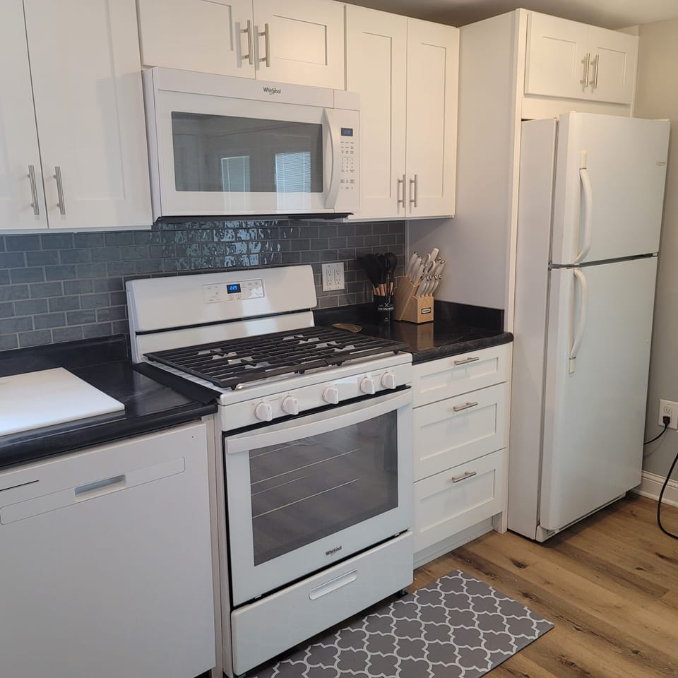 Full kitchen with gas range, microwave, refrigerator, and dishwasher
