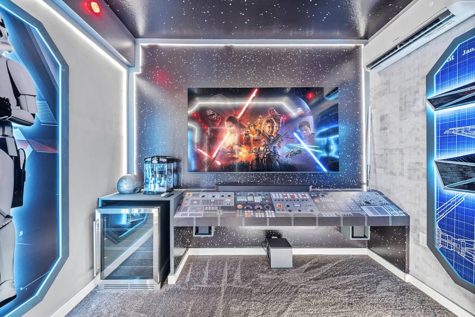 Experience our immersive entertainment room with vibrant blue lighting and modern decor. The large screen, framed by impressive wall art, is ideal for movie nights or gaming marathons, while the stylish furniture encourages cozy.