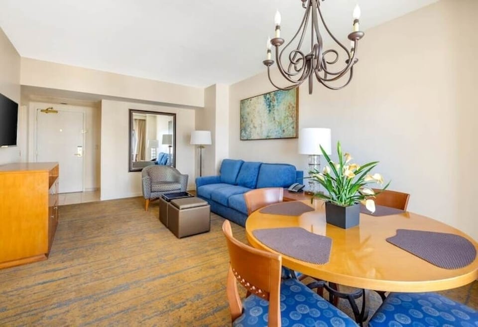 Gather for meals beneath warm lighting at the dining table.